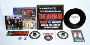 The Hymans - Rocker (7" vinyl, booze002, testpress, black vinyl in a screenprinted 3-color metal-box, 12 copies. + The Hymans sticker, The Hymans iron-on sticker, The Hymans 1” pin, The Hymans "Videoinsanity" CD, Bootleg Booze Records sticker, Bootleg Booze Records iron-on sticker, Bootleg Booze Records 1” pin, Flyer signed by The Hymans)